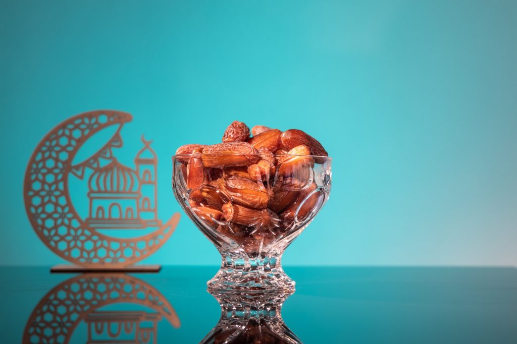 Muslim iftar of breaking of fast during Ramadan month with preserved sweet dates.. Decorative