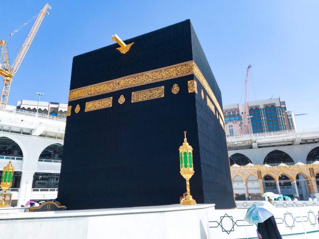 Pilgrims in Kaaba in Macca al Haram - umrah Socially Distanced coronavirus restrictions face mask